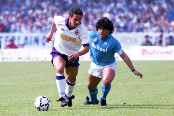 A young Roberto Baggio takes on Diego Maradona during Fiorentina v Napoli